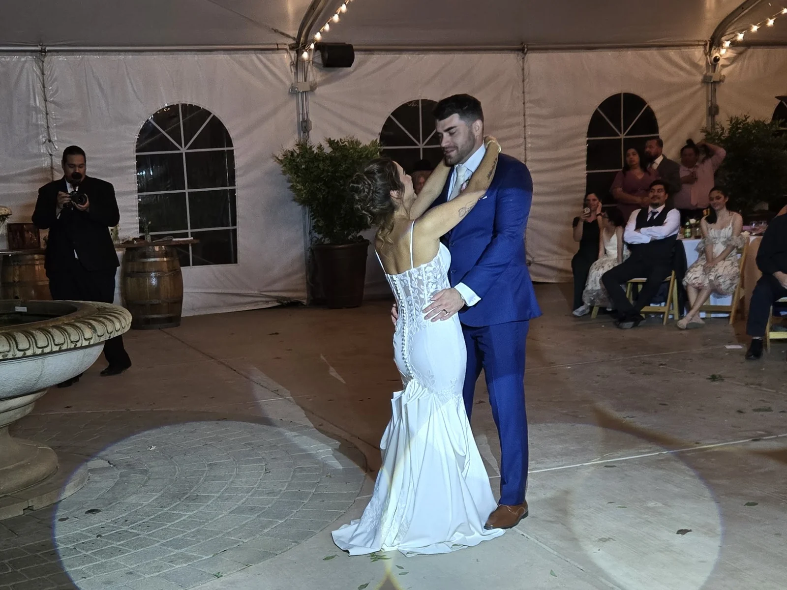Couple's first dance on gobo-lit floor in a tented wedding reception