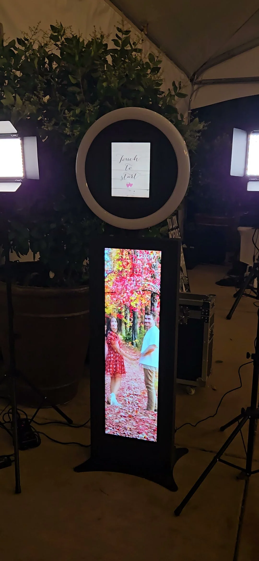 J Crew Productions digital LED photo booth next to the DJ booth at a night wedding reception