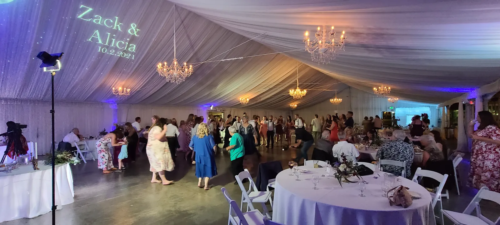 Colorful uplighting and custom monogram at a tented wedding reception at Haggin Oaks, Sacramento
