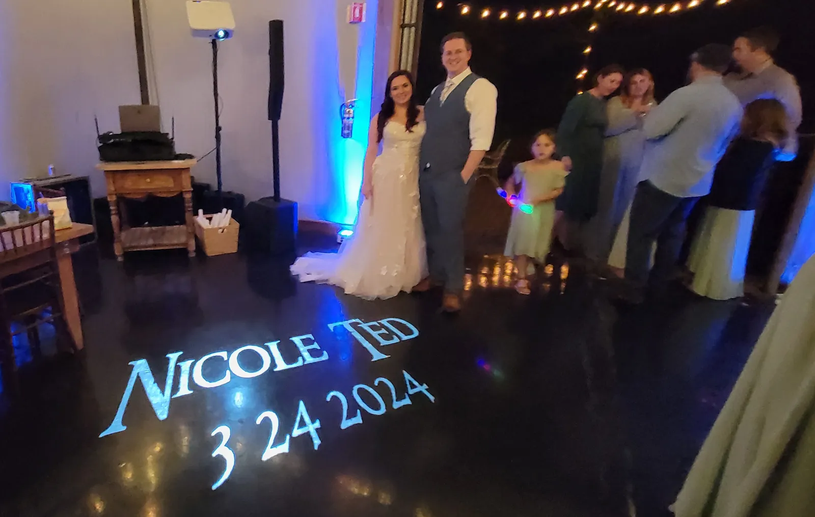 Custom name and wedding date monogram projected on the dance floor with blue uplighting by J Crew Productions